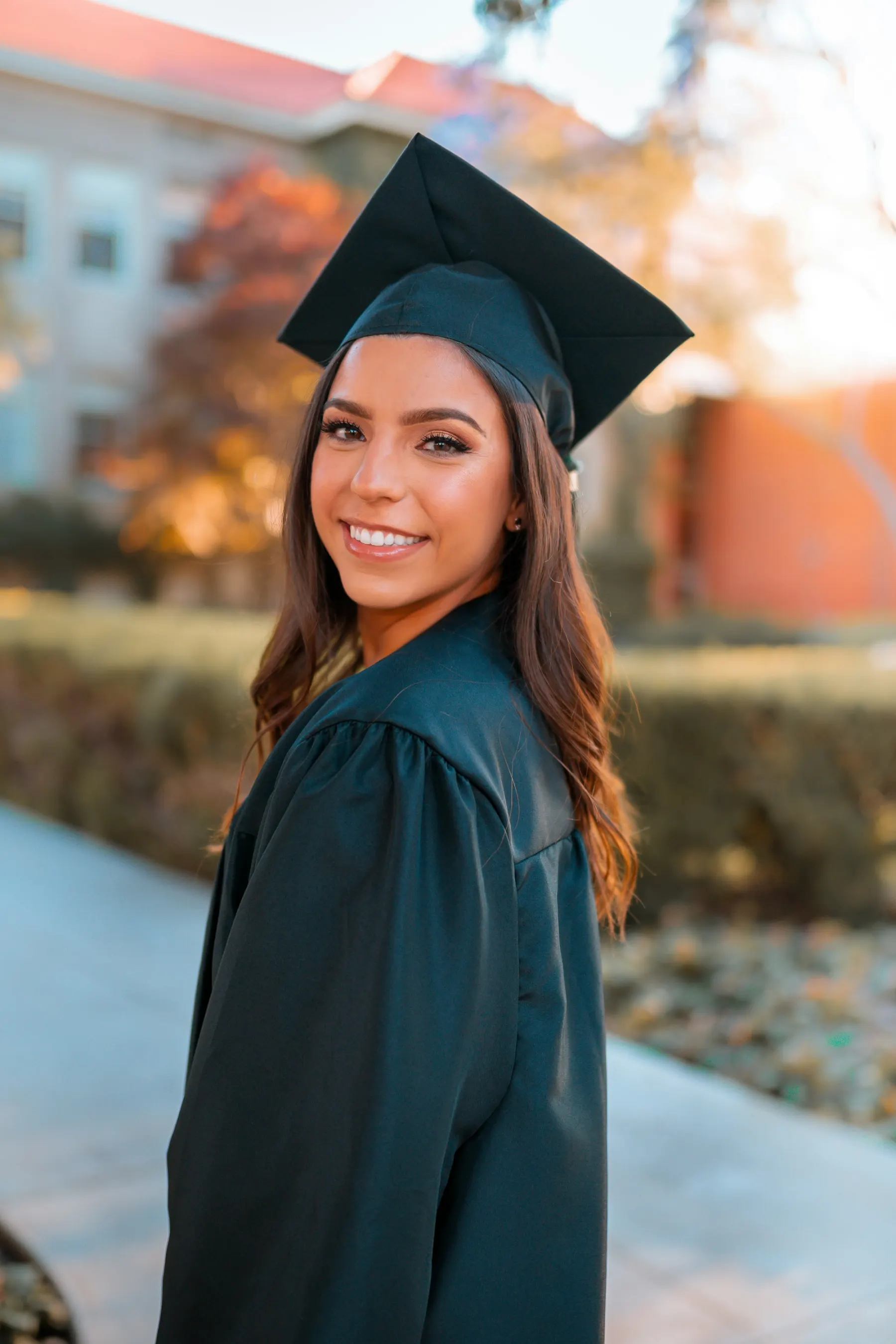 A smiling graduate in cap and gown