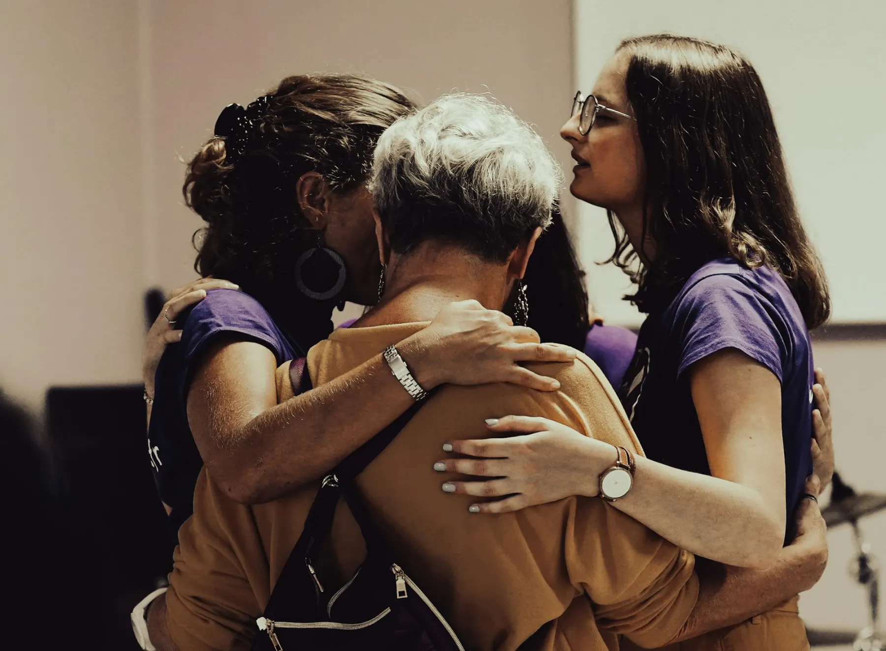 A family embracing their grandmother