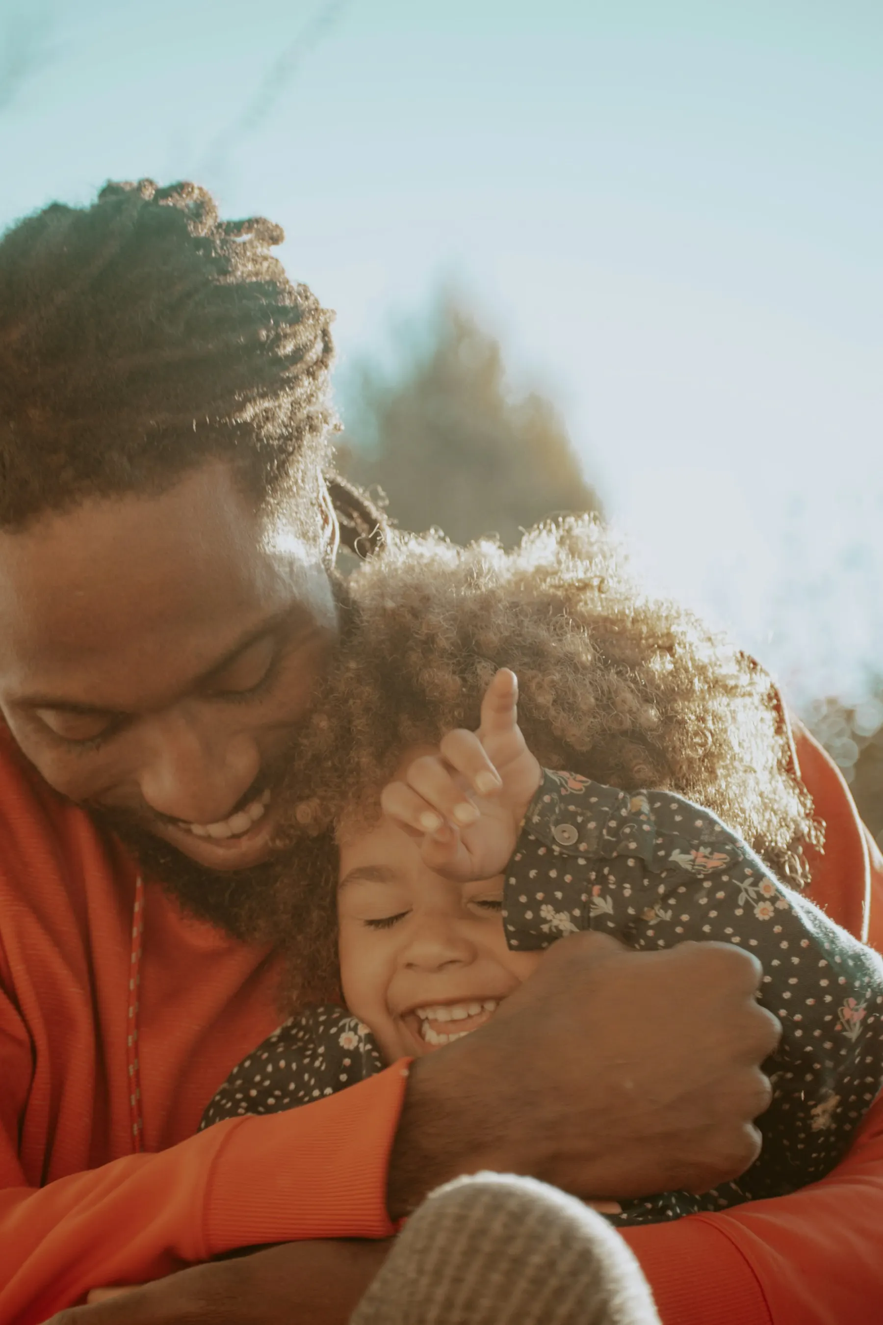 A father hugging his young daughter
